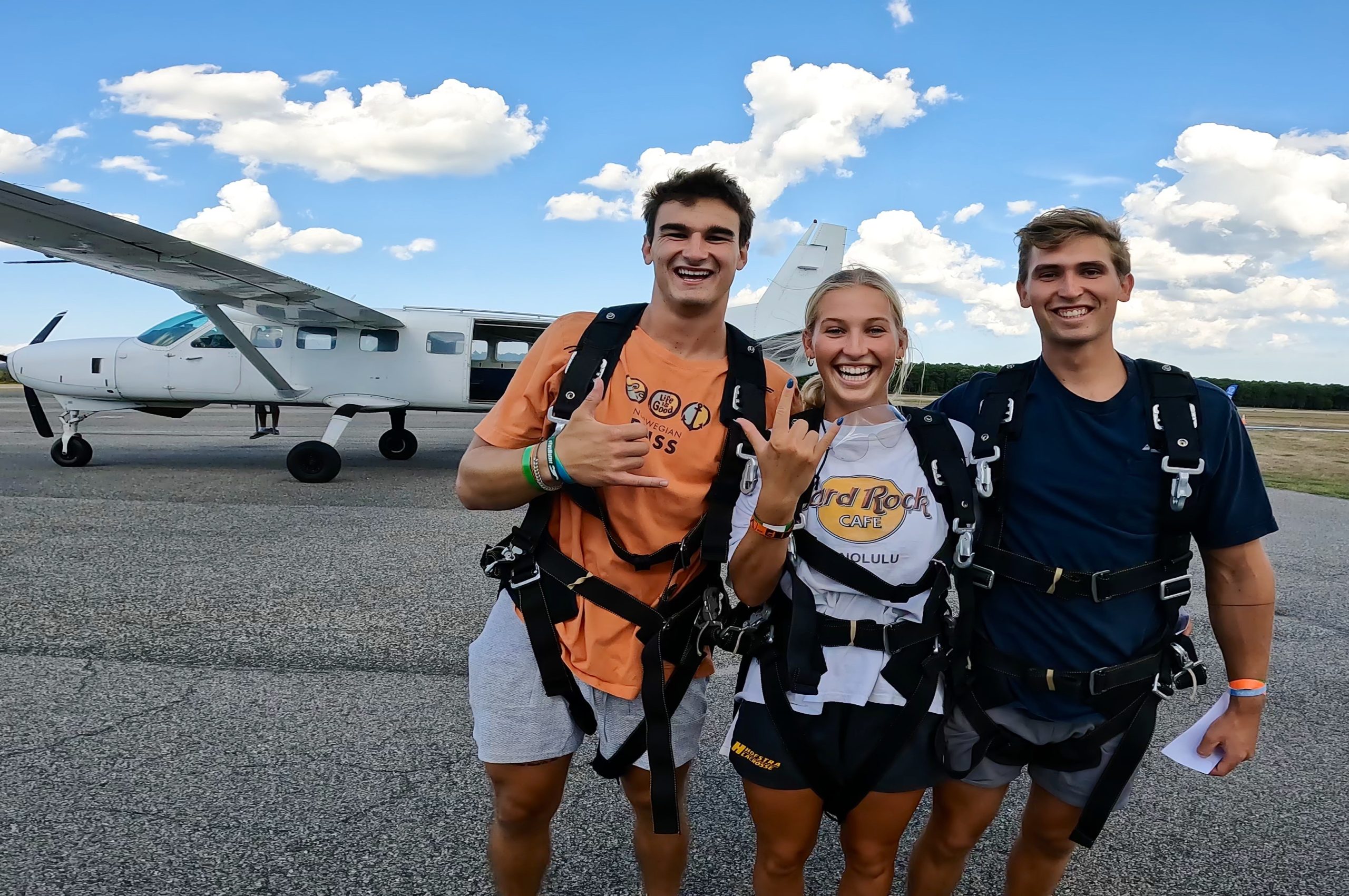 Three excited people looking forward to skydiving.
