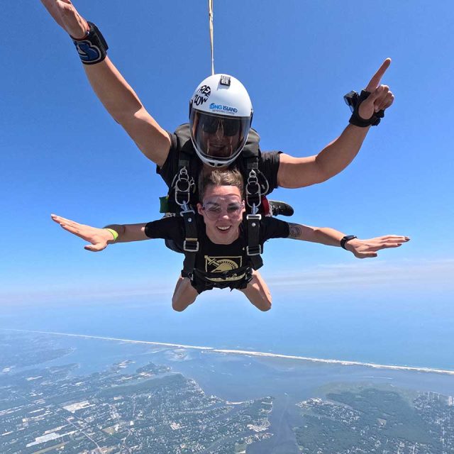 woman tandem skydiving with an instructor