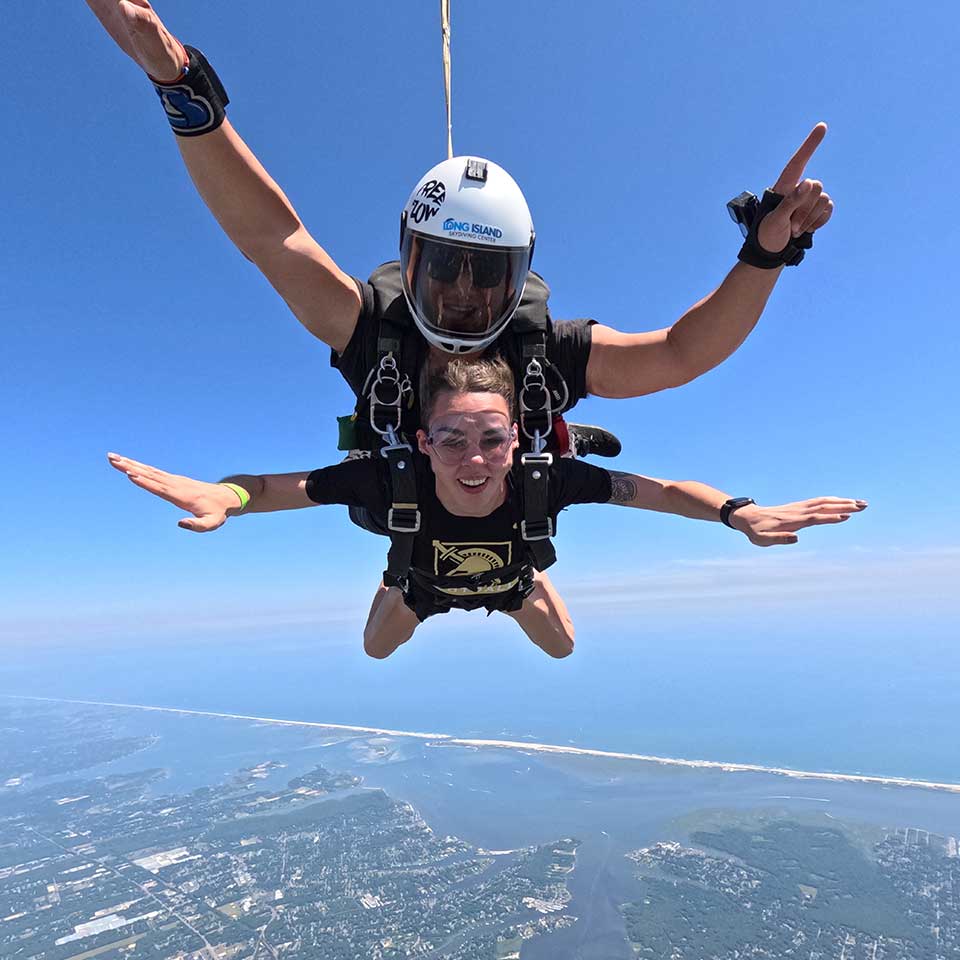 woman tandem skydiving with an instructor