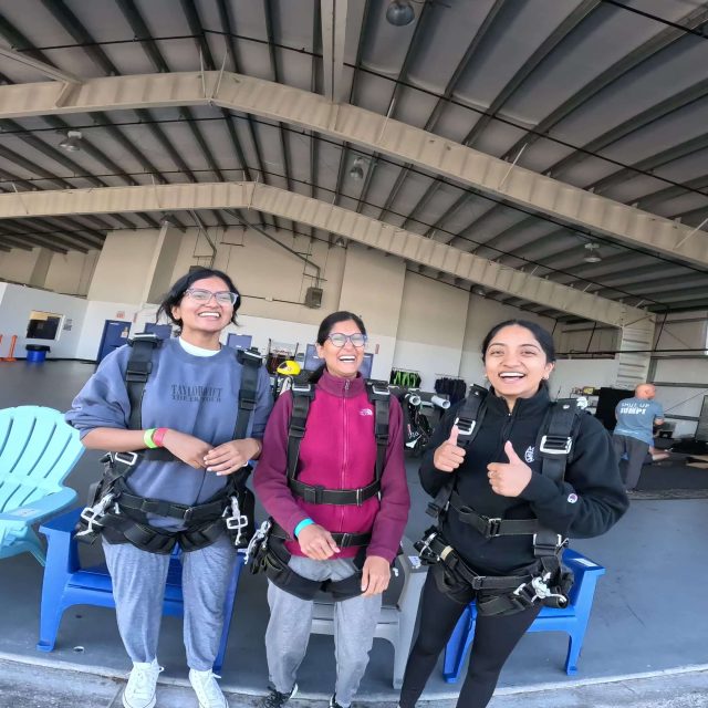 Group of 3 excited and ready to go on a plane for an skydiving adventure.