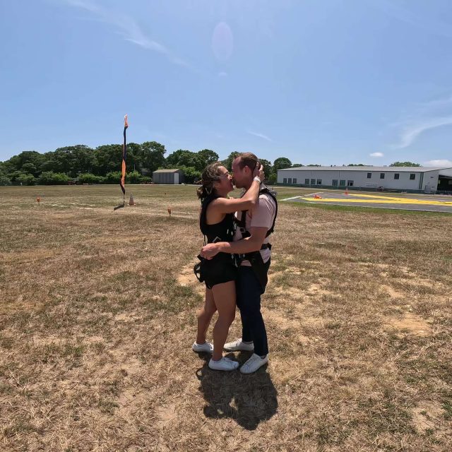 Couple kissing after their first skydive in New York.